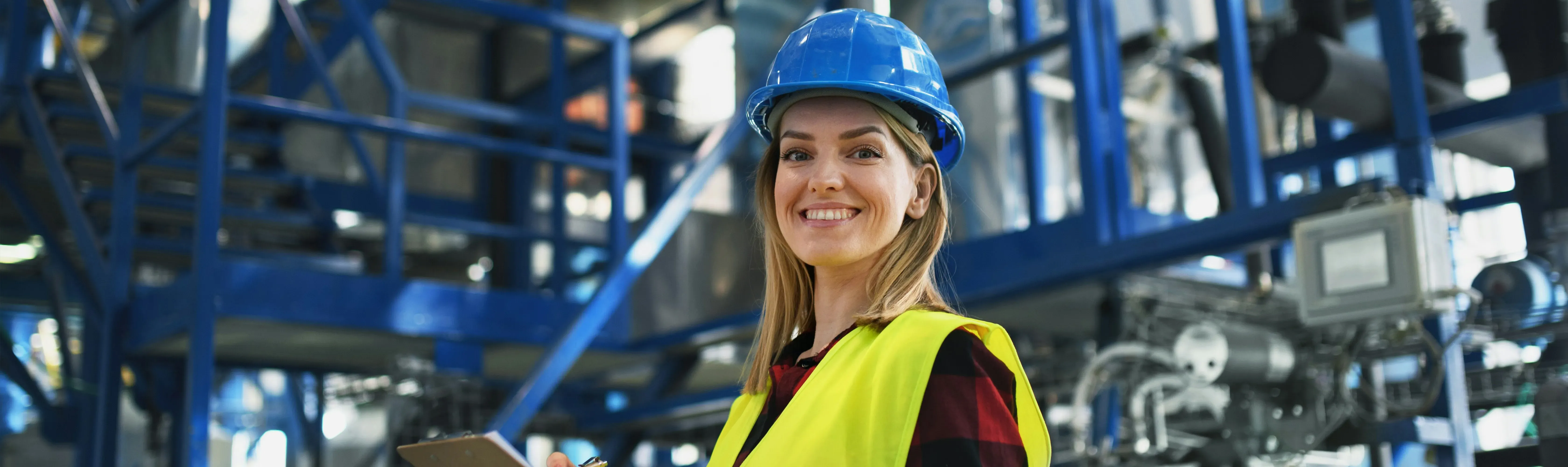 Woman in warehouse wearing PPE